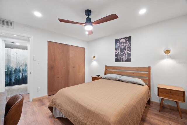 bedroom featuring light wood-type flooring, a closet, and ceiling fan