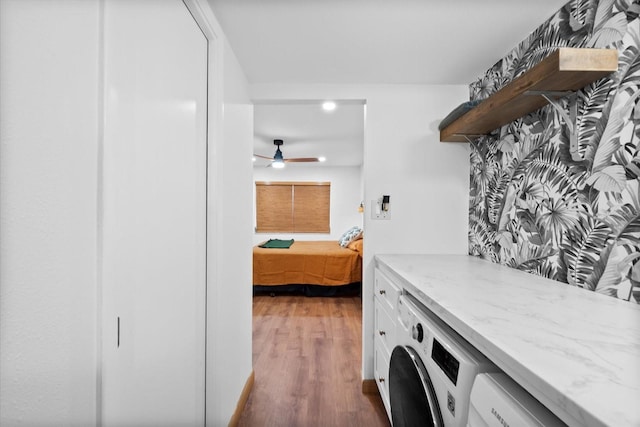 clothes washing area featuring hardwood / wood-style floors, ceiling fan, and washer / dryer