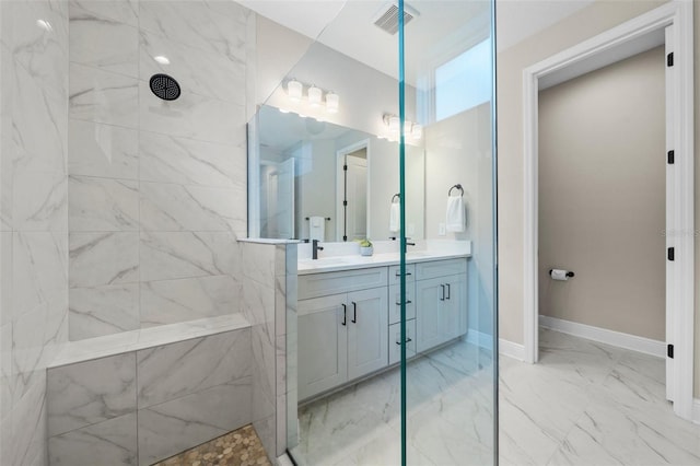 bathroom with vanity and tiled shower