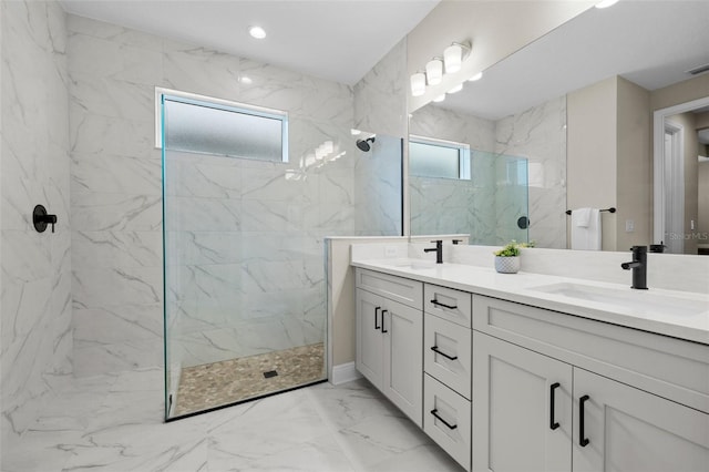 bathroom with vanity and tiled shower