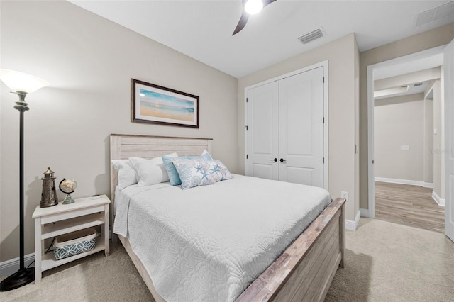 carpeted bedroom with a closet and ceiling fan