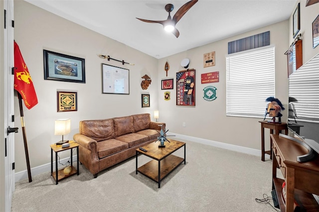 carpeted living room with ceiling fan