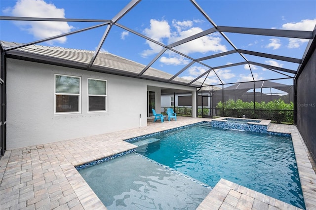 view of pool with glass enclosure, an in ground hot tub, and a patio