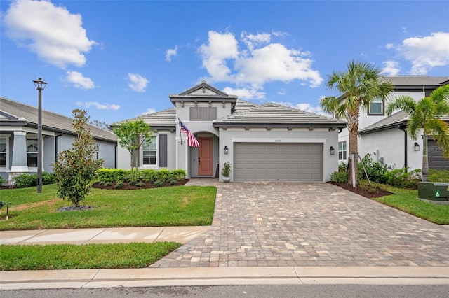 view of front of house with a front yard and a garage