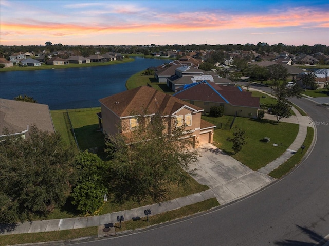 aerial view at dusk with a water view