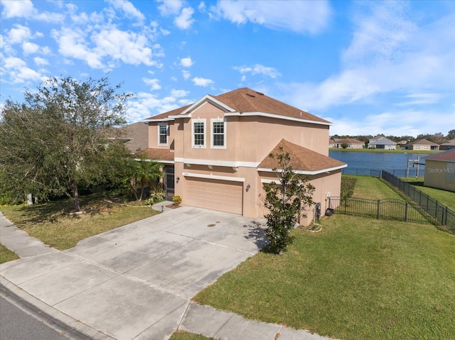 view of front of house with a garage, a front yard, and a water view