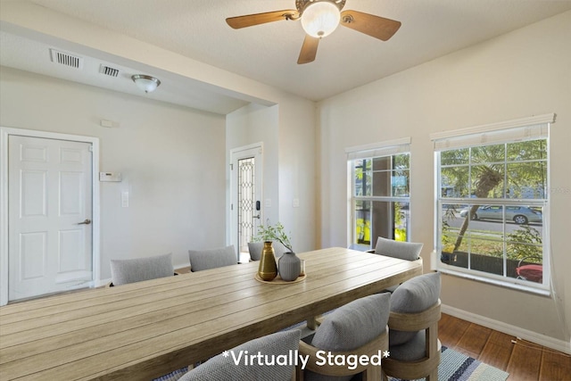 dining room with hardwood / wood-style flooring and ceiling fan