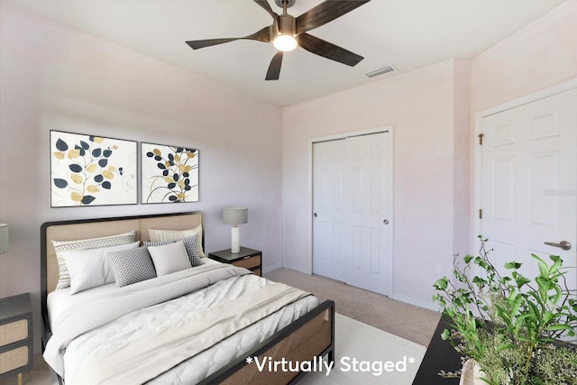 bedroom featuring ceiling fan, light carpet, and a closet