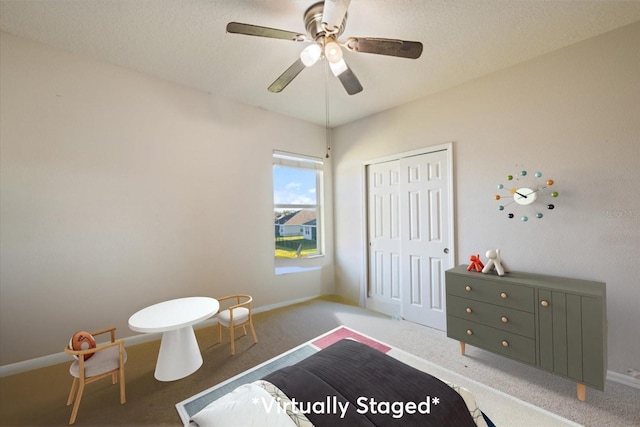 bedroom with ceiling fan, a textured ceiling, a closet, and carpet