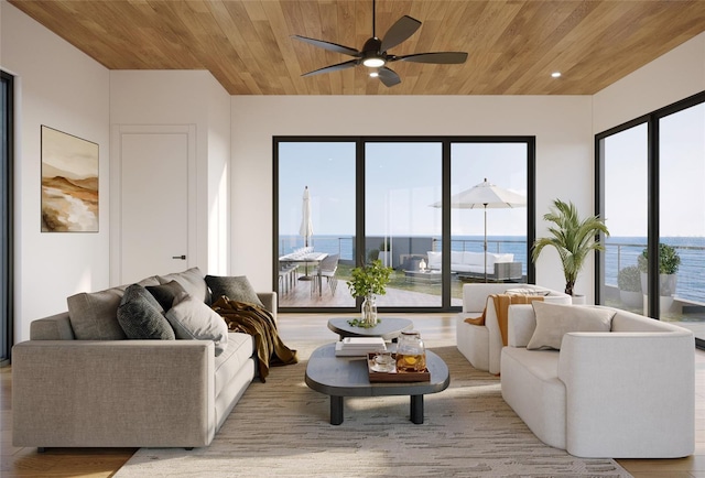 living room with ceiling fan, a water view, a wealth of natural light, and wood ceiling