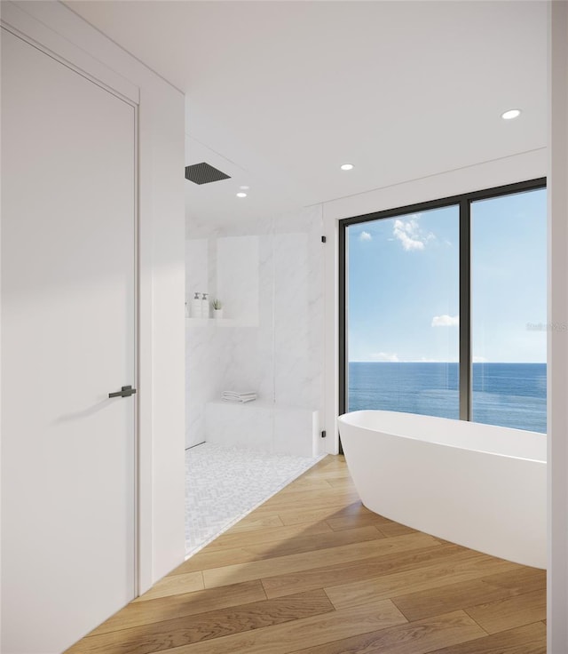 3200 Higel Ave, Sarasota, FL 34242 - bathroom with a walk in shower, a freestanding bath, wood finished floors, and recessed lighting