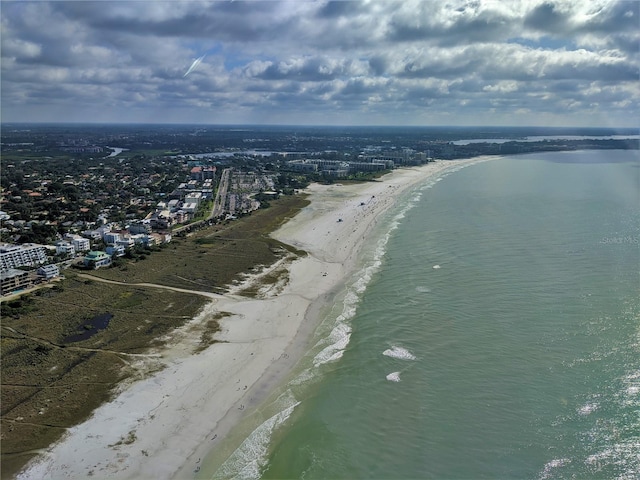 bird's eye view featuring a water view and a beach view