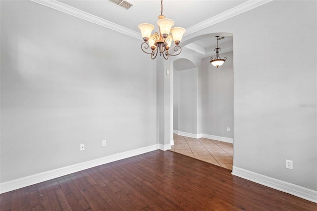 spare room featuring hardwood / wood-style floors and crown molding