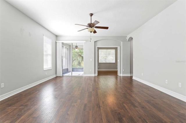 unfurnished living room featuring dark hardwood / wood-style floors and ceiling fan