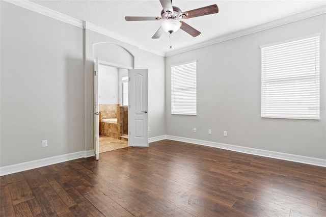 unfurnished bedroom featuring ornamental molding, ensuite bathroom, ceiling fan, and dark hardwood / wood-style floors