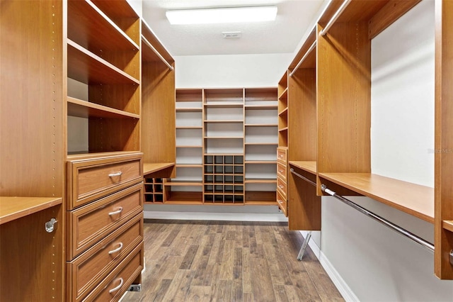 spacious closet featuring dark hardwood / wood-style floors