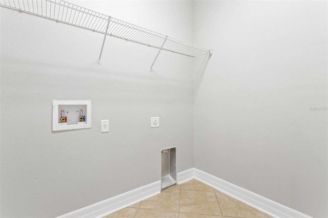 clothes washing area featuring washer hookup, light tile patterned floors, and electric dryer hookup