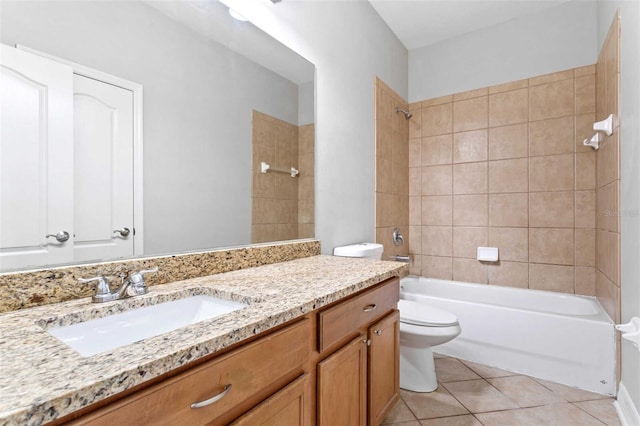 full bathroom featuring vanity, tile patterned flooring, toilet, and tiled shower / bath