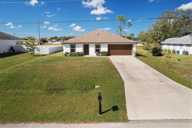 view of front of property featuring a front yard, central AC, and a garage