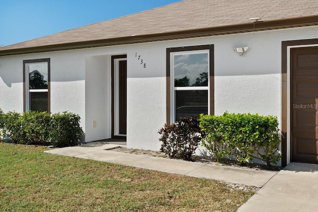 entrance to property with a yard