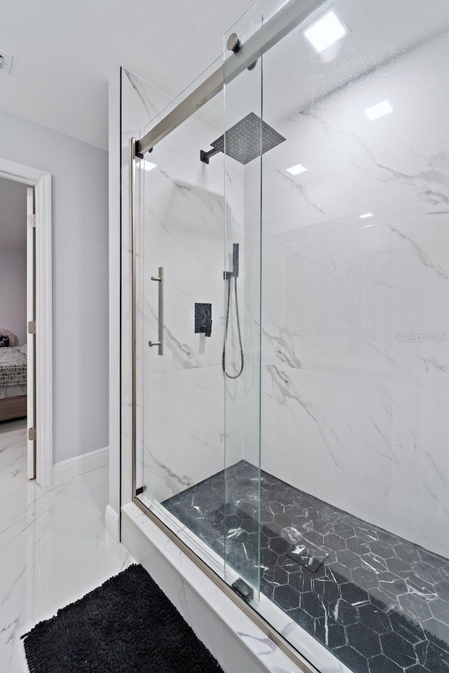 bathroom with a shower with door