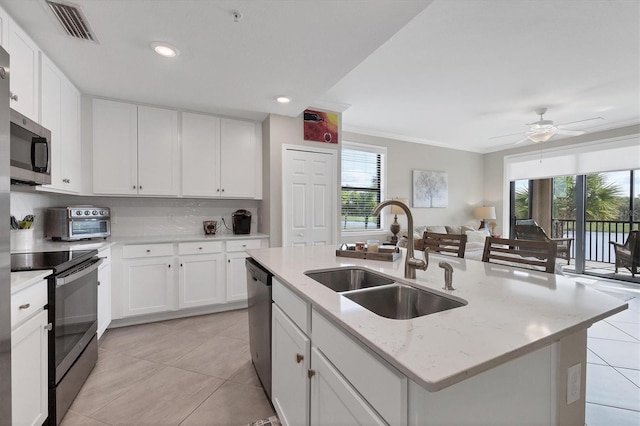 kitchen featuring a kitchen island with sink, sink, a healthy amount of sunlight, and stainless steel appliances