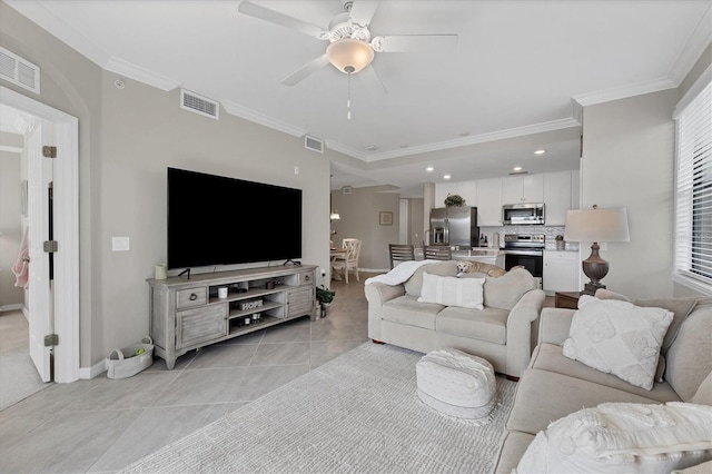 tiled living room featuring ceiling fan and crown molding