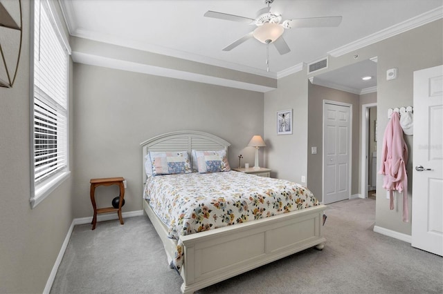 carpeted bedroom with ceiling fan, a closet, and ornamental molding