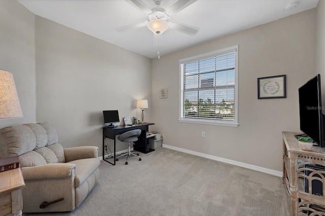 carpeted home office featuring ceiling fan