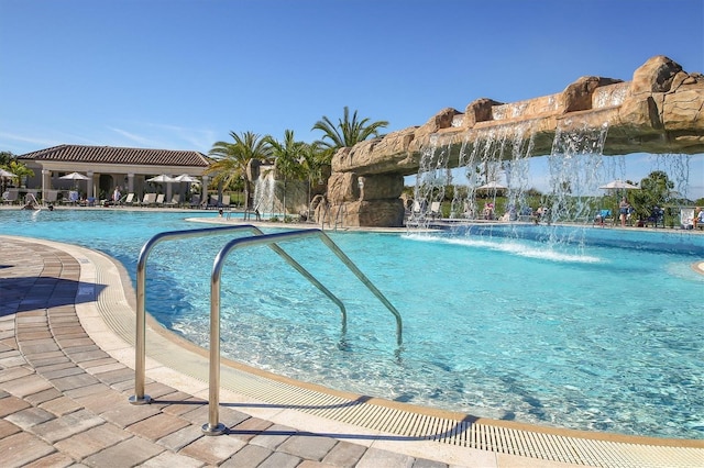 view of swimming pool with pool water feature