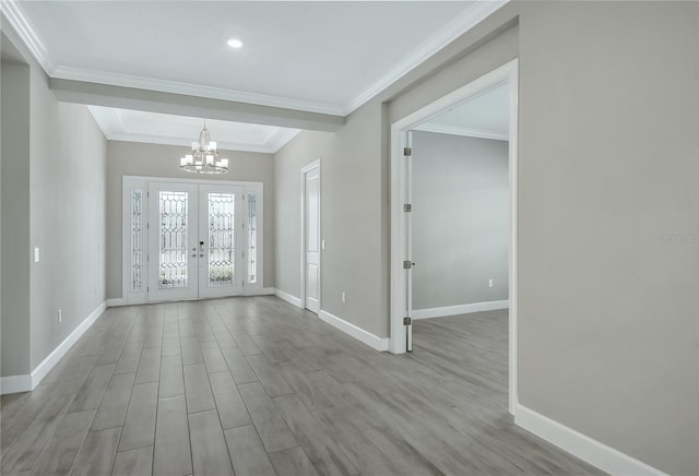 entryway featuring french doors, ornamental molding, and an inviting chandelier