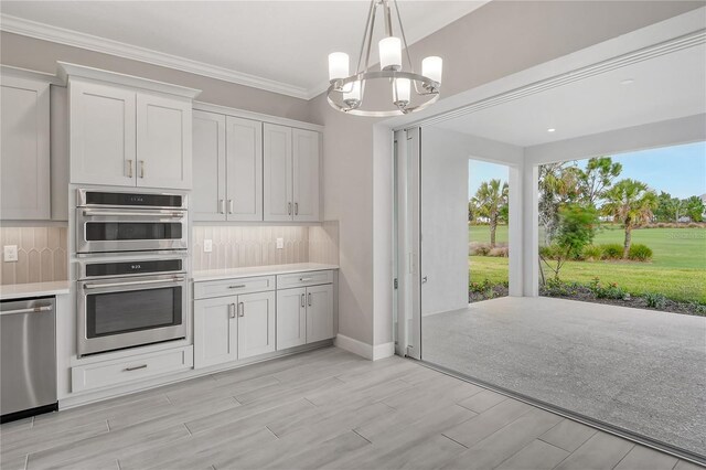 15625 San Lazzaro Ave, Bradenton, FL 34211 - kitchen featuring appliances with stainless steel finishes, tasteful backsplash, healthy amount of natural light, and ornamental molding
