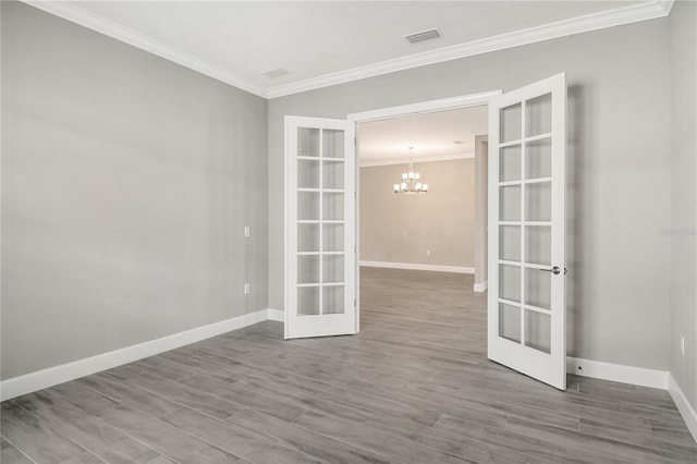 15625 San Lazzaro Ave, Bradenton, FL 34211 - spare room featuring french doors, a chandelier, crown molding, and wood finished floors
