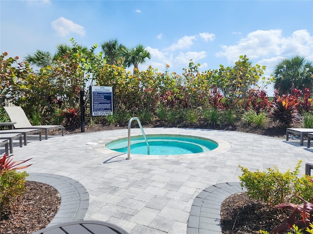 view of swimming pool with a patio and a community hot tub