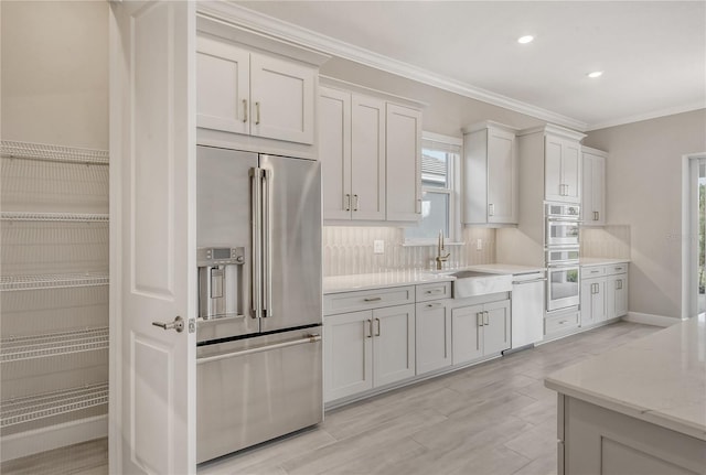 15625 San Lazzaro Ave, Bradenton, FL 34211 - kitchen featuring stainless steel appliances, tasteful backsplash, crown molding, light wood-style flooring, and recessed lighting