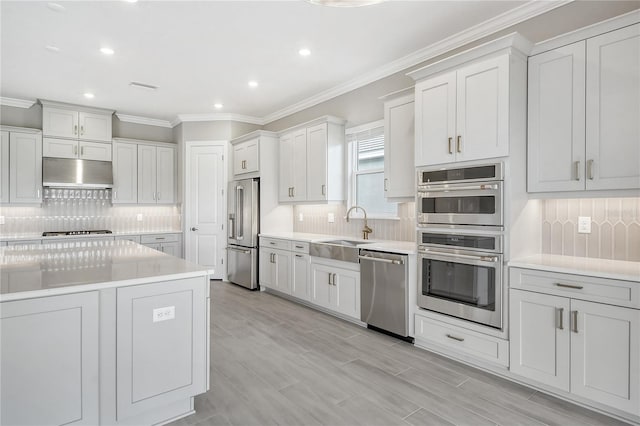 15625 San Lazzaro Ave, Bradenton, FL 34211 - kitchen featuring stainless steel appliances, under cabinet range hood, tasteful backsplash, recessed lighting, and ornamental molding