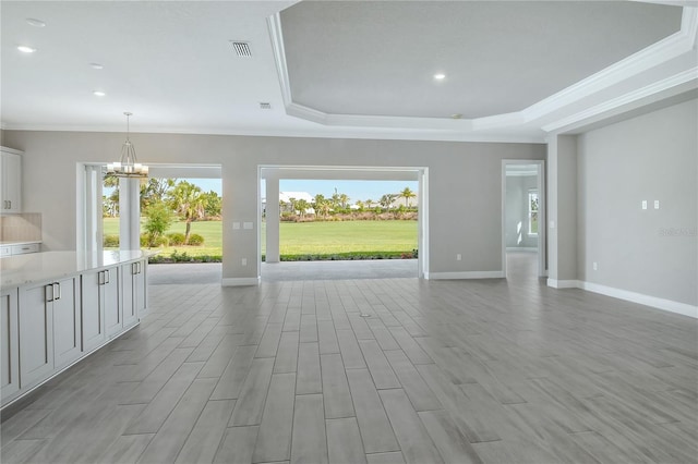 15625 San Lazzaro Ave, Bradenton, FL 34211 - unfurnished living room featuring a chandelier, plenty of natural light, ornamental molding, recessed lighting, and a raised ceiling