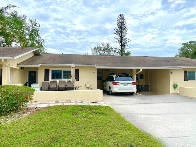 ranch-style home with a front yard and a carport