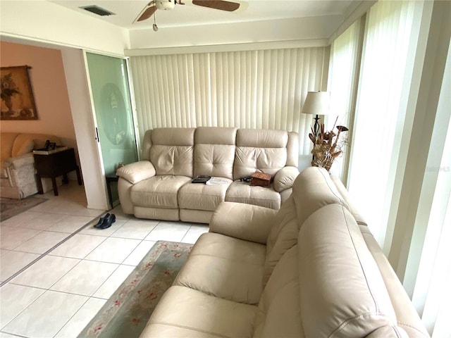 tiled living room with ceiling fan