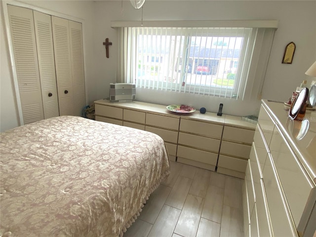 bedroom featuring light wood-type flooring and a closet