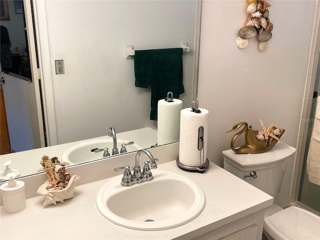 bathroom with vanity, toilet, and an enclosed shower