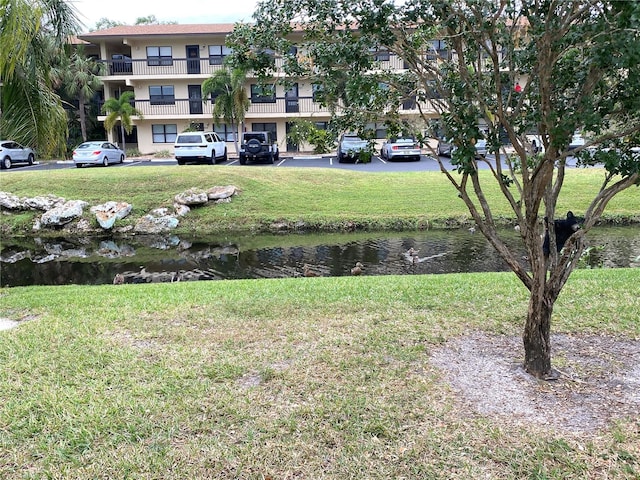 view of yard featuring a water view and a balcony