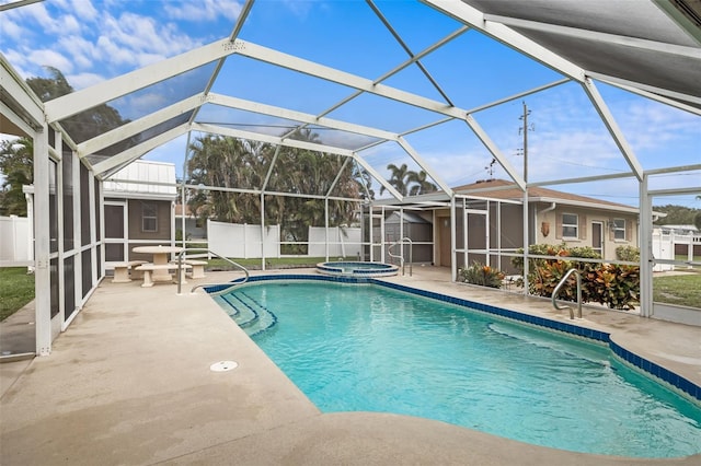 view of pool featuring a patio, a lanai, and an in ground hot tub