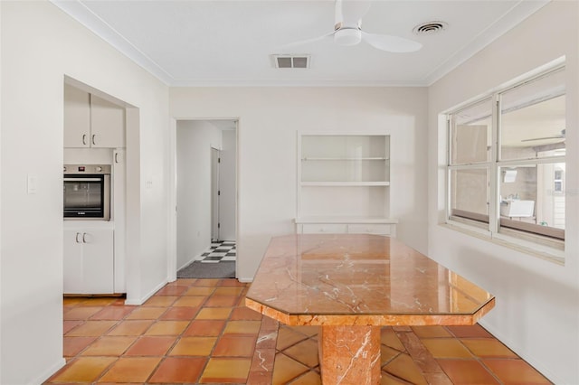 unfurnished dining area with ornamental molding, ceiling fan, and light tile patterned flooring