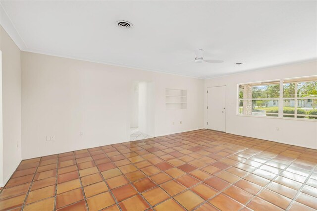 spare room featuring built in features, tile patterned floors, ceiling fan, and crown molding