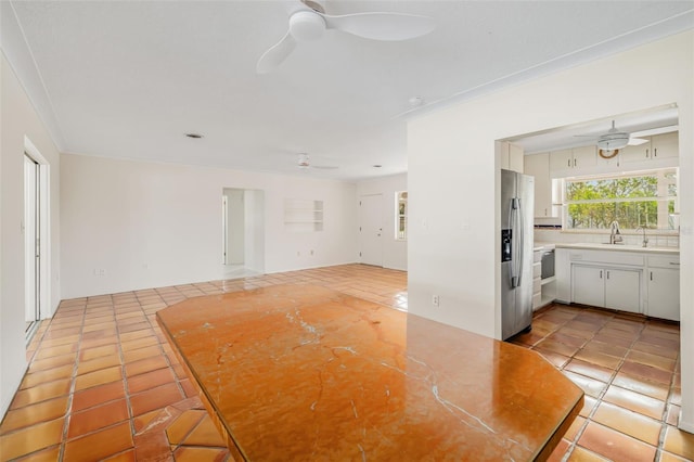 interior space with light tile patterned floors and sink