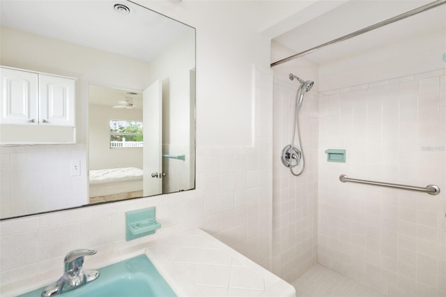 bathroom featuring a tile shower and backsplash