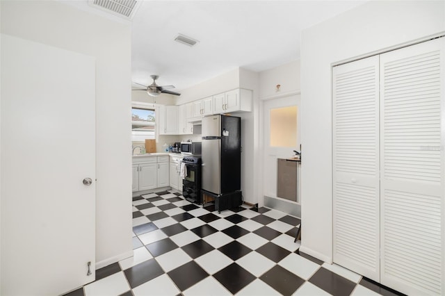 kitchen with white cabinets, stainless steel appliances, ceiling fan, and sink