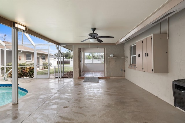 unfurnished sunroom featuring ceiling fan