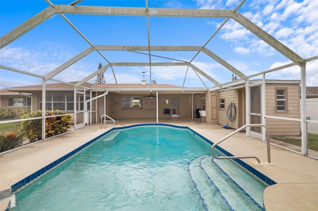 view of swimming pool featuring a lanai and a patio